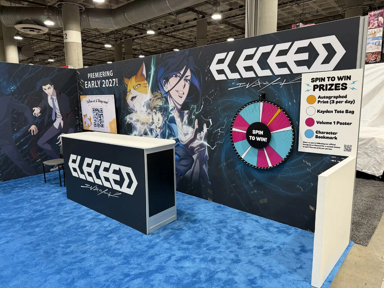 Eleceed exhibit at Anime Expo with large character graphics and a prize wheel