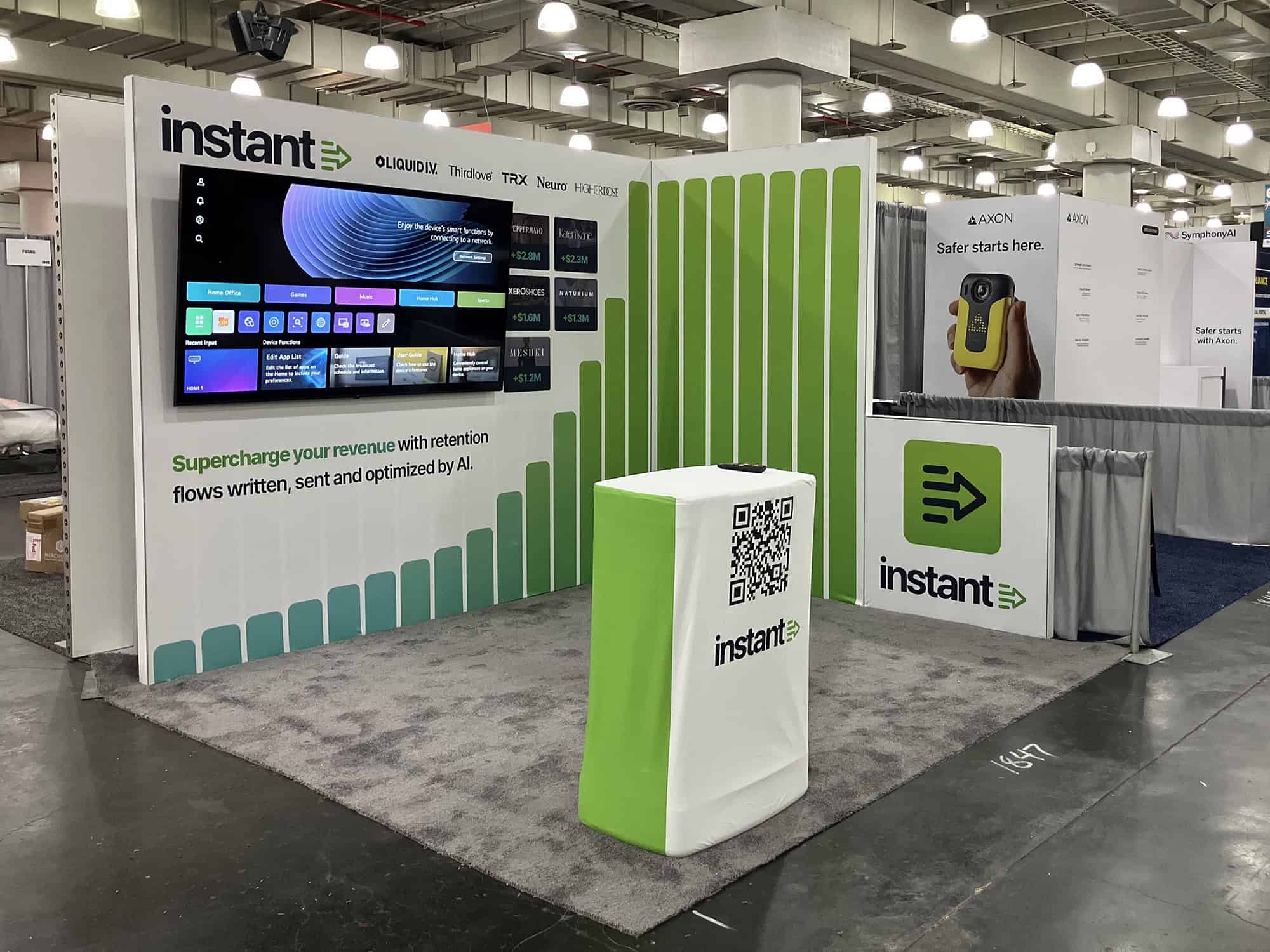 A modern trade show booth with digital displays and branded graphics, designed to attract visitors and showcase innovative solutions at expos and conferences.
